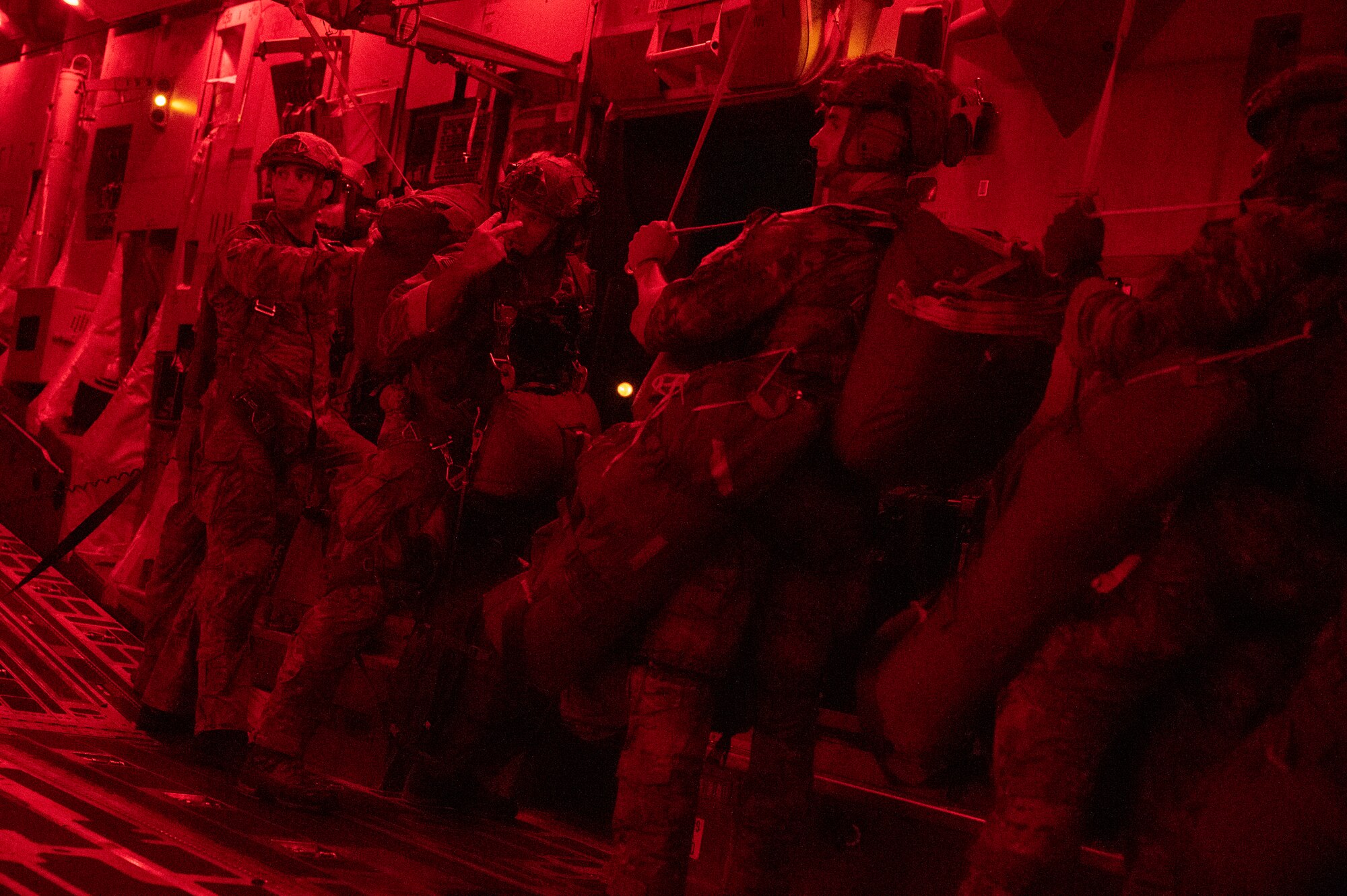 Army rangers prepare to jump out of a C-17 Globemaster III.