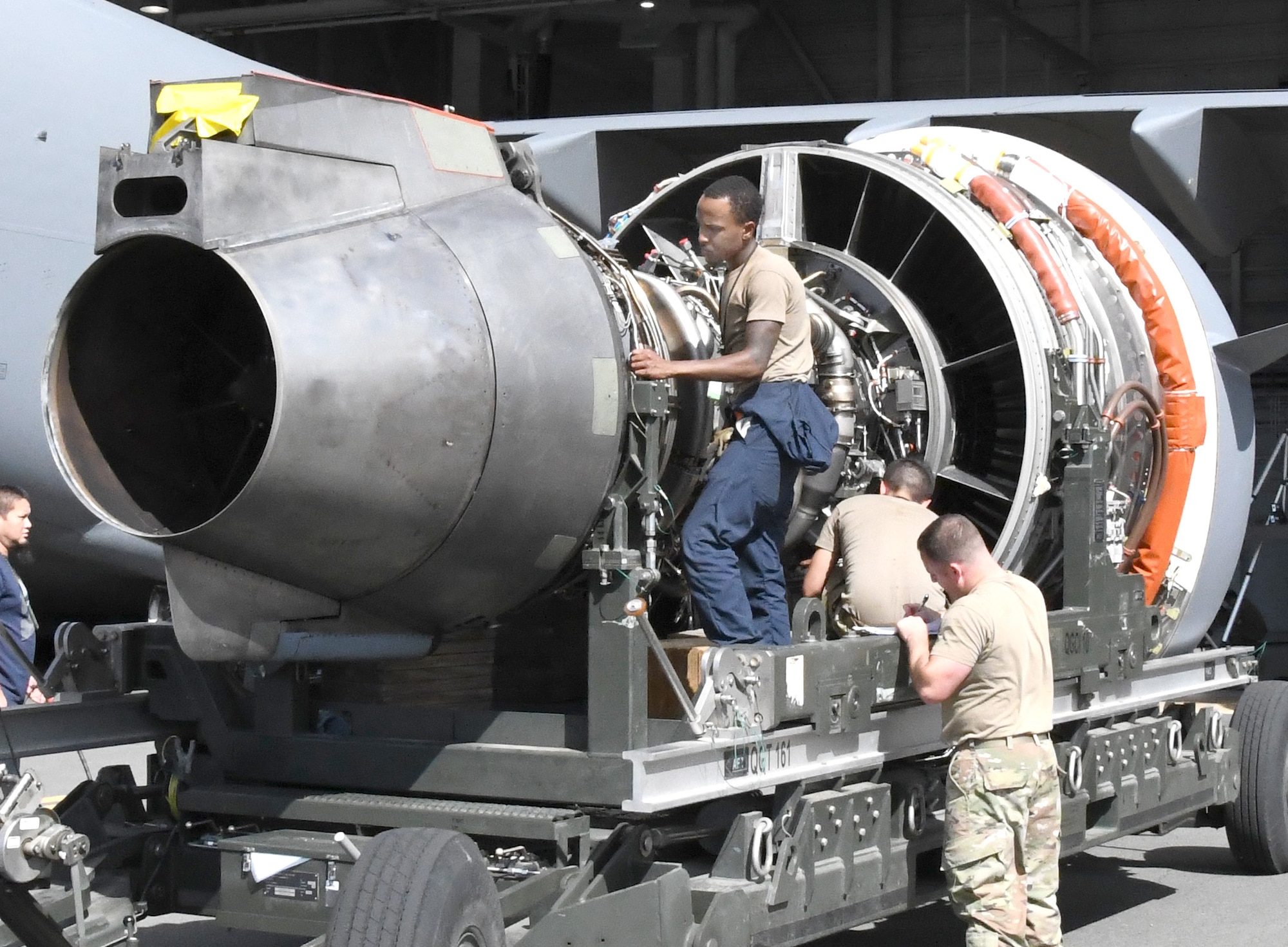 U.S. Air Force Senior Airman Lake Harper, left, and Tech. Sgt. Derek Lescord, both assigned to the 735th Air Mobility Squadron, prepare a C-17 Globemaster III engine for installation at Joint Base Pearl Harbor-Hickam, Hawaii on Aug. 19, 2022. (U.S. Air Force photo by Amelia Dickson)