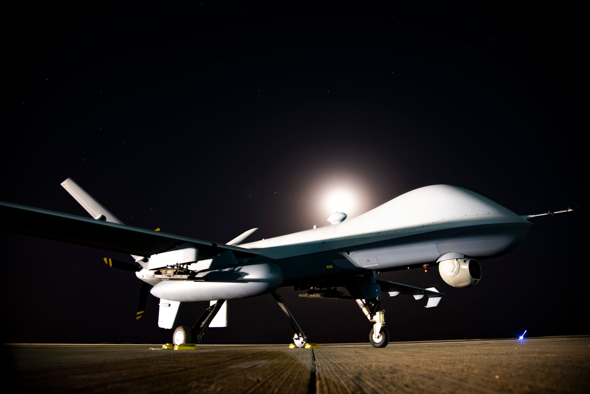 Long exposure photo of an MQ-9 Reaper on the 361 Expeditionary Attack Squadron flight line at an undisclosed location, August 6, 2022. The MQ-9 is an unmanned aircraft capable of remote controlled or autonomous flight. The 361 EAS operates them in support of Operation Inherent Resolve. (U.S. Air Force photo by: Tech. Sgt. Jim Bentley)
