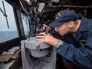 TAIWAN STRAIT (AUG 28, 2022) Ensign Minor Wetzel, from La Canada, California, right, takes ship bearing as Ensign Patrick Brady, from Dephaven, Minnesota, searches for surface contacts in the bridge as Ticonderoga-class guided-missile cruiser USS Antietam (CG 54) conducts routine Taiwan Strait Transit. Antietam is deployed to 7th Fleet area of operations in support of a free and open Indo-Pacific. (U.S. Navy photo by Mass Communication Specialist 3rd Class Santiago Navarro)