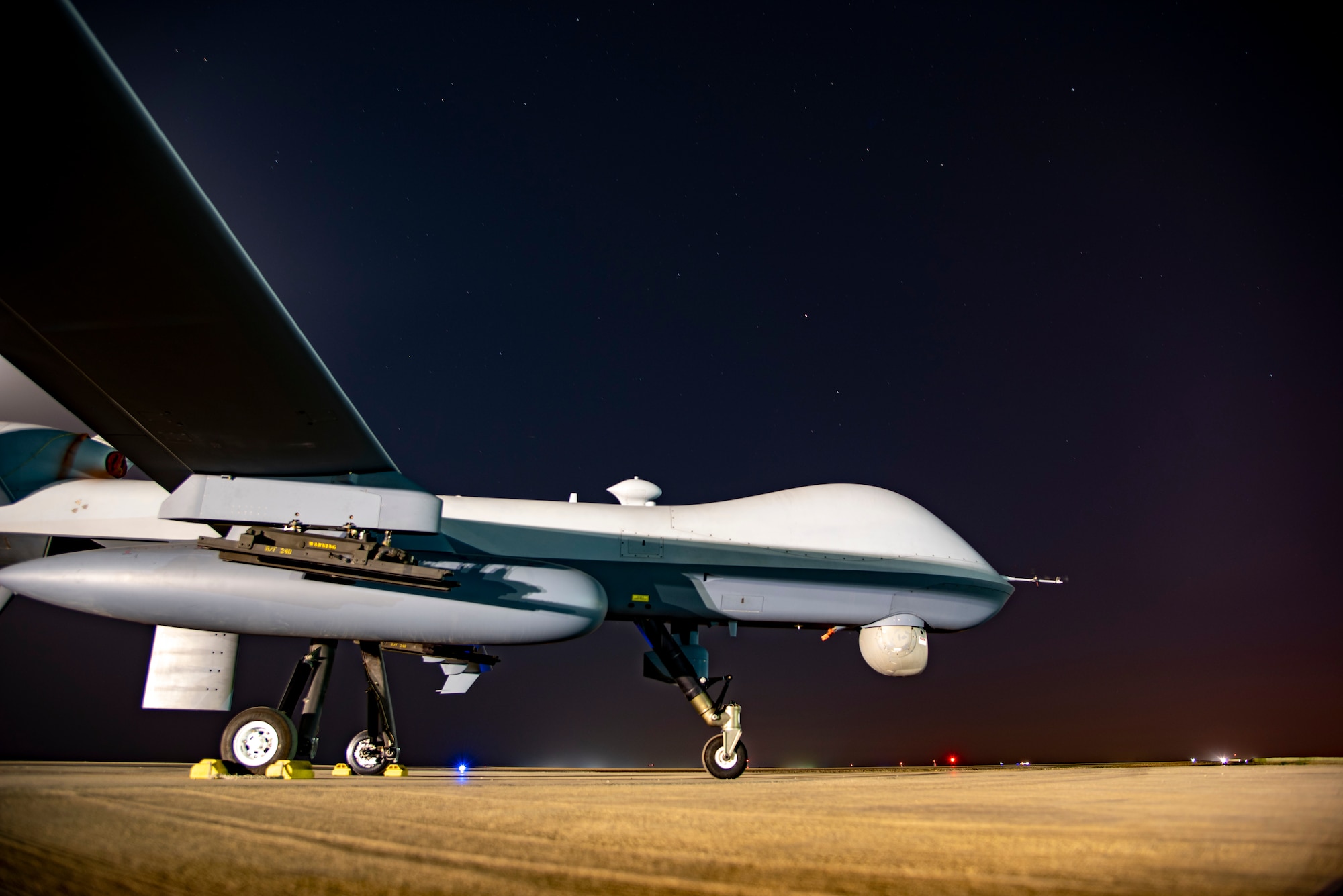 Long exposure photo of an MQ-9 Reaper on the 361 Expeditionary Attack Squadron flight line at an undisclosed location, August 6, 2022. The MQ-9 is an unmanned aircraft capable of remote controlled or autonomous flight. The 361 EAS operates them in support of Operation Inherent Resolve. (U.S. Air Force photo by: Tech. Sgt. Jim Bentley)