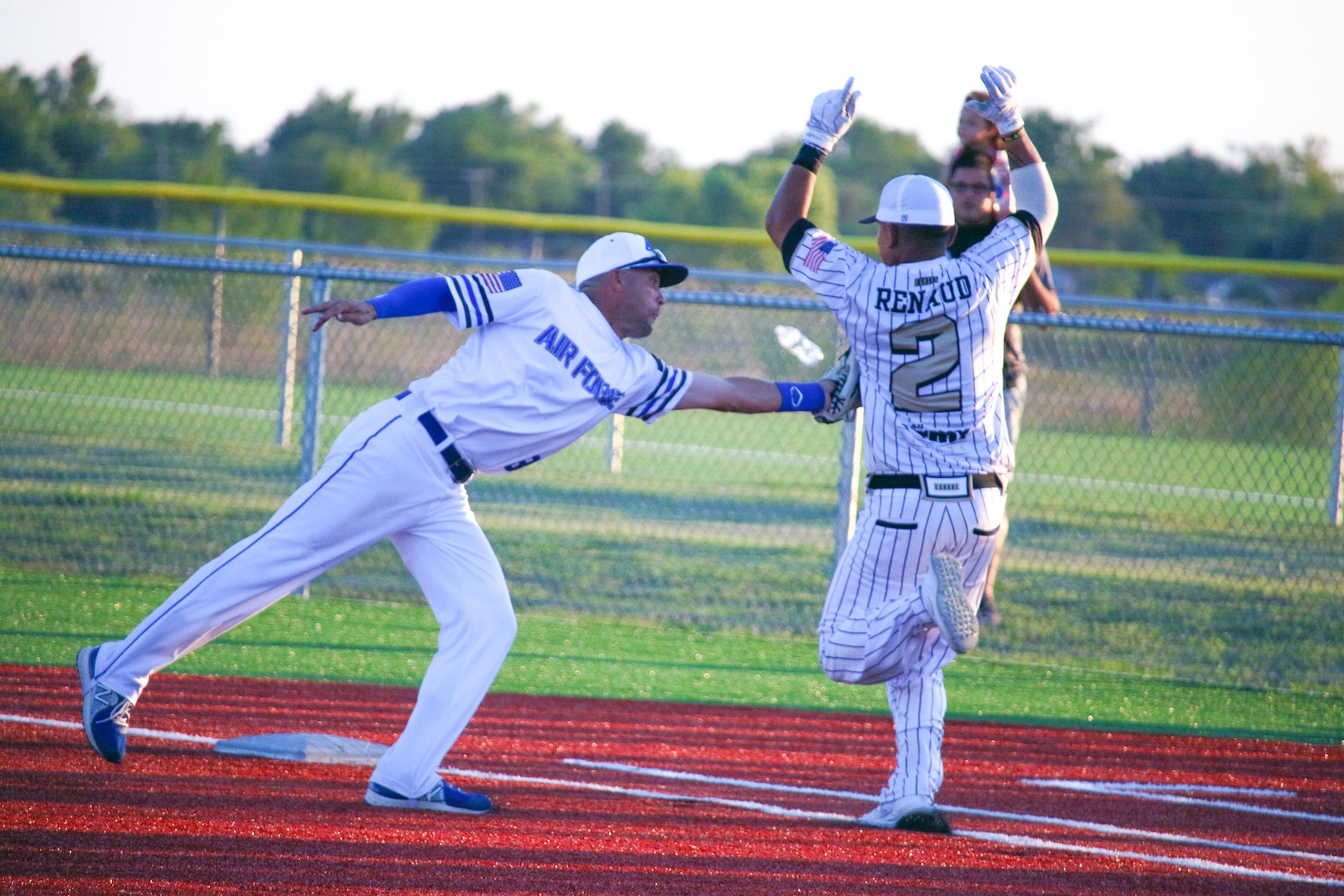 Air Force first baseman Tech. Sgt. Todd Duncan of Kunsan Air Base, South Korea tags out Army Staff Sgt. Andrew Renaud of US Army Recruiting Stockton, CA during the championship game of the 2022 Armed Forces Sports Men's Softball Championship hosted by Army at Fort Sill, Okla.  Championship features teams from the Army, Marine Corps, Navy, and Air Force.