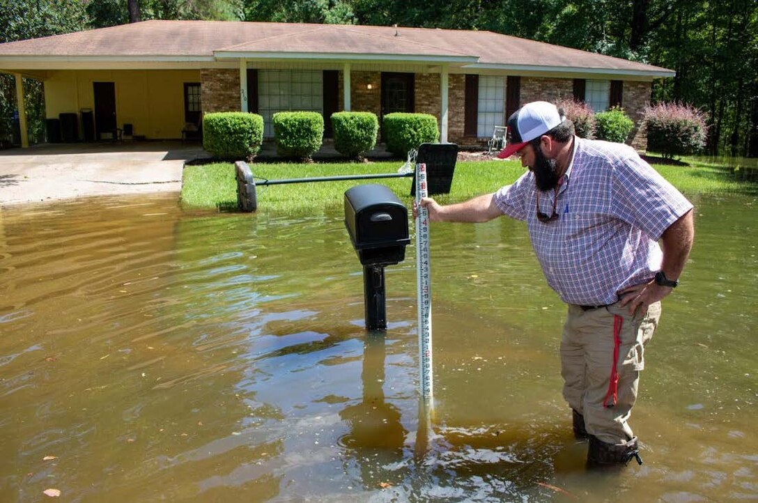 USACE Vicksburg District Jay Hogue measures water level on River Road, Jackson, Mississippi, during the Pearl River flood event, Aug. 27, 2022.
