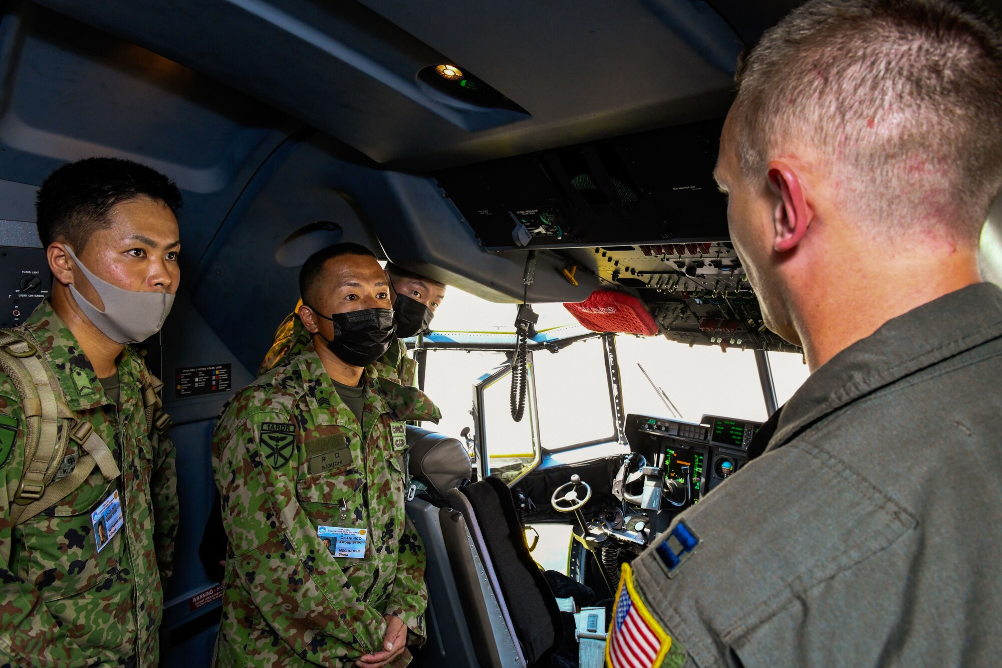 Japan Ground Self-Defense Force Sgt. Katsuya Nakakubo, left, and Master Sgt. Shota Iguchi, middle, listen as U.S. Air Force Capt. David Hood, 36th Airlift Squadron C-130J Super Hercules pilot, briefs them on the capabilities of the C-130J, at Yokota Air Base, Japan, Aug. 9, 2022. Members of the JGSDF along with U.S. Army Soldiers from Camp Zama, Japan, visited Yokota, as part of a six-week cooperative work program. This program is an opportunity for JGSDF and U.S. Army service members to improve bilateral relations, enhance language comprehension skills, learn about each others cultures and familiarize themselves with bilateral military doctrine and techniques. (U.S. Air Force photo by Tech. Sgt. Garrett Cole)