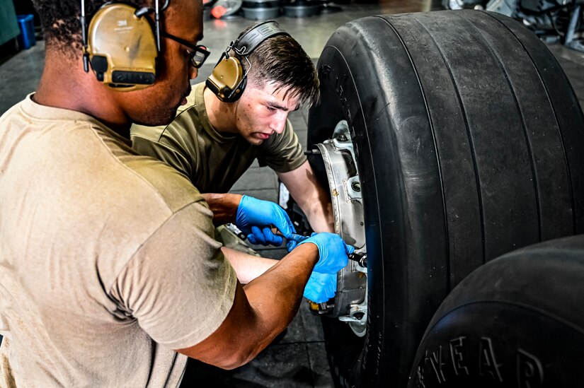 U.S. Air Force Senior Airman Rodney Alston III, 305th Maintenance Squadron crew chief, performs wheel maintenance at Joint Base McGuire-Dix-Lakehurst, N.J. on Aug. 26, 2022. Crew Chiefs in the Wheel and Tire Section of 305 MXS are validating their local ability to breakdown and build-up tire assemblies for the KC-46's main landing gear and nose landing gear. At the beginning of August 2022, the Air Force Life Cycle Management Center authorized Main Operating Bases to stand up organic tire change capability. A four member team consisting of Crew Chiefs, Sheet Metal, and Nondestructive Inspection went to Altus Air Force Base for initial training and familiarization. By validating local ability to breakdown and build-up tire assemblies for the KC-46, the 305th MXS brings a new capability to JB MDL and will be able to improve support for the KC-46 throughout the Air Force. (U.S. Air Force photo by Senior Airman Matt Porter)