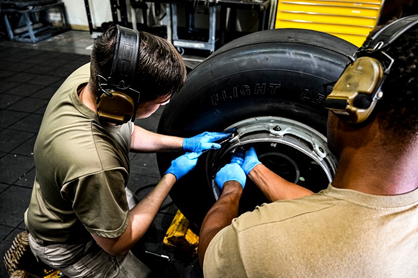 U.S. Air Force Senior Airman Rodney Alston III, 305th Maintenance Squadron crew chief, performs wheel maintenance at Joint Base McGuire-Dix-Lakehurst, N.J. on Aug. 26, 2022. Crew Chiefs in the Wheel and Tire Section of 305 MXS are validating their local ability to breakdown and build-up tire assemblies for the KC-46's main landing gear and nose landing gear. At the beginning of August 2022, the Air Force Life Cycle Management Center authorized Main Operating Bases to stand up organic tire change capability. A four member team consisting of Crew Chiefs, Sheet Metal, and Nondestructive Inspection went to Altus Air Force Base for initial training and familiarization. By validating local ability to breakdown and build-up tire assemblies for the KC-46, the 305th MXS brings a new capability to JB MDL and will be able to improve support for the KC-46 throughout the Air Force. (U.S. Air Force photo by Senior Airman Matt Porter)