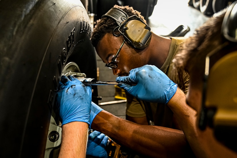 U.S. Air Force Senior Airman Rodney Alston III, 305th Maintenance Squadron crew chief, performs wheel maintenance at Joint Base McGuire-Dix-Lakehurst, N.J. on Aug. 26, 2022. Crew Chiefs in the Wheel and Tire Section of 305 MXS are validating their local ability to breakdown and build-up tire assemblies for the KC-46's main landing gear and nose landing gear. At the beginning of August 2022, the Air Force Life Cycle Management Center authorized Main Operating Bases to stand up organic tire change capability. A four member team consisting of Crew Chiefs, Sheet Metal, and Nondestructive Inspection went to Altus Air Force Base for initial training and familiarization. By validating local ability to breakdown and build-up tire assemblies for the KC-46, the 305th MXS brings a new capability to JB MDL and will be able to improve support for the KC-46 throughout the Air Force. (U.S. Air Force photo by Senior Airman Matt Porter)