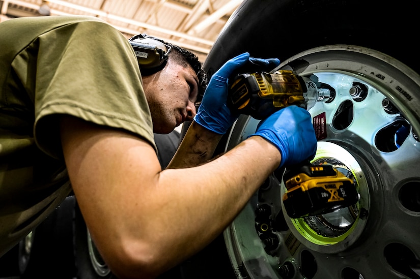 U.S. Air Force Staff. Sgt. Nathan Sturgeon, 305th Maintenance Squadron crew chief, performs wheel maintenance at Joint Base McGuire-Dix-Lakehurst, N.J. on Aug. 26, 2022. Crew Chiefs in the Wheel and Tire Section of 305 MXS are validating their local ability to breakdown and build-up tire assemblies for the KC-46's main landing gear and nose landing gear. At the beginning of August 2022, the Air Force Life Cycle Management Center authorized Main Operating Bases to stand up organic tire change capability. A four member team consisting of Crew Chiefs, Sheet Metal, and Nondestructive Inspection went to Altus Air Force Base for initial training and familiarization. By validating local ability to breakdown and build-up tire assemblies for the KC-46, the 305th MXS brings a new capability to JB MDL and will be able to improve support for the KC-46 throughout the Air Force. (U.S. Air Force photo by Senior Airman Matt Porter)