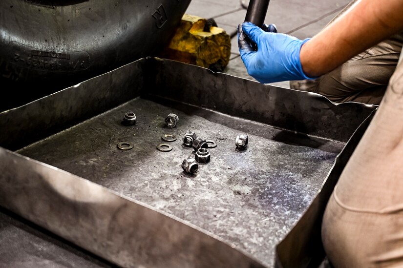 U.S. Air Force Staff. Sgt. Nathan Sturgeon, 305th Maintenance Squadron crew chief, performs wheel maintenance at Joint Base McGuire-Dix-Lakehurst, N.J. on Aug. 26, 2022. Crew Chiefs in the Wheel and Tire Section of 305 MXS are validating their local ability to breakdown and build-up tire assemblies for the KC-46's main landing gear and nose landing gear. At the beginning of August 2022, the Air Force Life Cycle Management Center authorized Main Operating Bases to stand up organic tire change capability. A four member team consisting of Crew Chiefs, Sheet Metal, and Nondestructive Inspection went to Altus Air Force Base for initial training and familiarization. By validating local ability to breakdown and build-up tire assemblies for the KC-46, the 305th MXS brings a new capability to JB MDL and will be able to improve support for the KC-46 throughout the Air Force. (U.S. Air Force photo by Senior Airman Matt Porter)