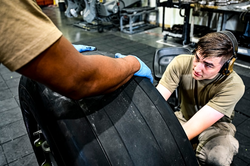 U.S. Air Force Staff. Sgt. Nathan Sturgeon, 305th Maintenance Squadron crew chief, performs a wheel inspection at Joint Base McGuire-Dix-Lakehurst, N.J. on Aug. 26, 2022. Crew Chiefs in the Wheel and Tire Section of 305 MXS are validating their local ability to breakdown and build-up tire assemblies for the KC-46's main landing gear and nose landing gear. At the beginning of August 2022, the Air Force Life Cycle Management Center authorized Main Operating Bases to stand up organic tire change capability. A four member team consisting of Crew Chiefs, Sheet Metal, and Nondestructive Inspection went to Altus Air Force Base for initial training and familiarization. By validating local ability to breakdown and build-up tire assemblies for the KC-46, the 305th MXS brings a new capability to JB MDL and will be able to improve support for the KC-46 throughout the Air Force. (U.S. Air Force photo by Senior Airman Matt Porter)