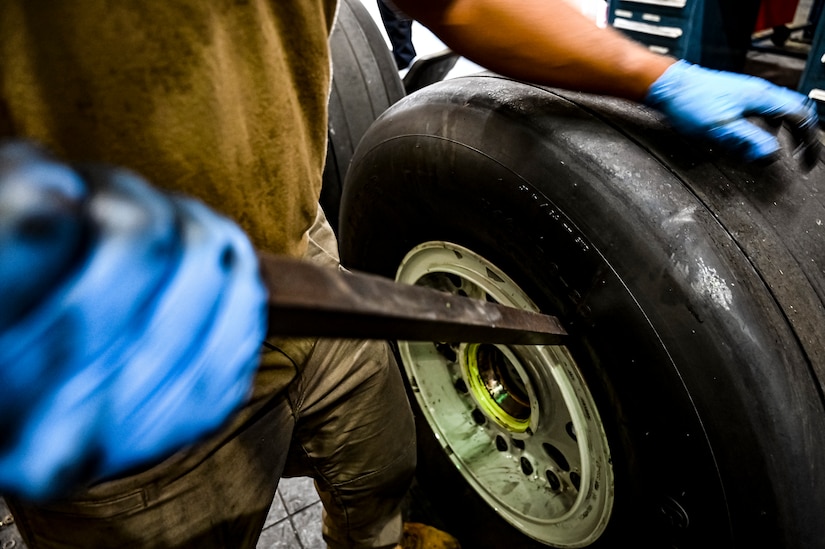 U.S. Air Force Senior Airman Rodney Alston III, 305th Maintenance Squadron crew chief, performs wheel maintenance at Joint Base McGuire-Dix-Lakehurst, N.J. on Aug. 26, 2022. Crew Chiefs in the Wheel and Tire Section of 305 MXS are validating their local ability to breakdown and build-up tire assemblies for the KC-46's main landing gear and nose landing gear. At the beginning of August 2022, the Air Force Life Cycle Management Center authorized Main Operating Bases to stand up organic tire change capability. A four member team consisting of Crew Chiefs, Sheet Metal, and Nondestructive Inspection went to Altus Air Force Base for initial training and familiarization. By validating local ability to breakdown and build-up tire assemblies for the KC-46, the 305th MXS brings a new capability to JB MDL and will be able to improve support for the KC-46 throughout the Air Force. (U.S. Air Force photo by Senior Airman Matt Porter)