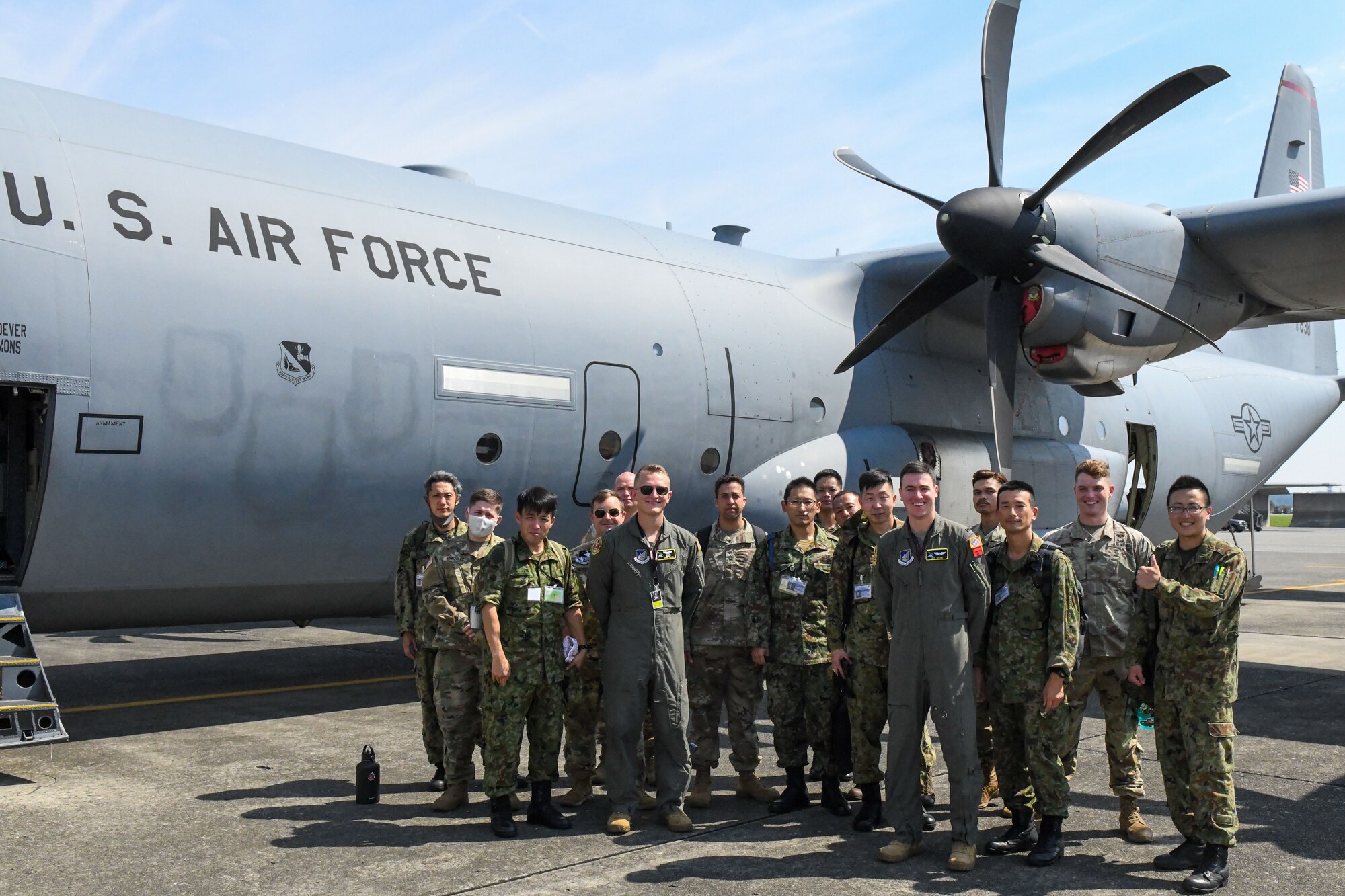 Members of the Japan Ground Self-Defense Force along with U.S. Army Soldiers from Camp Zama, Japan, and 374th Operations Group pilots gather for a group photo after completing a tour of a C-130J Super Hercules, at Yokota Air Base, Japan, Aug. 9, 2022. This group visited Yokota, as part of a six-week cooperative work program. This program is an opportunity for JGSDF and U.S. Army service members to improve bilateral relations, enhance language comprehension skills, learn about each others cultures and familiarize themselves with bilateral military doctrine and techniques. (U.S. Air Force photo by Tech. Sgt. Garrett Cole)