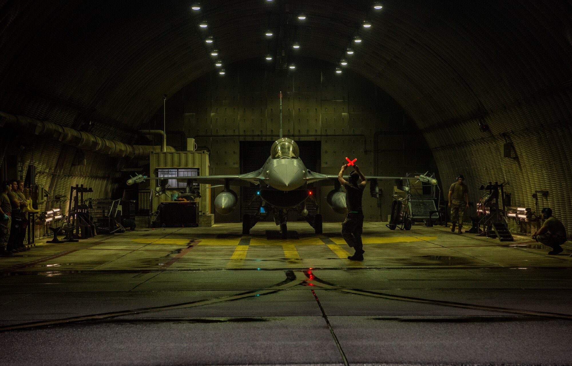 A crew chief assigned to the 36th Fighter Generation Squadron marshals an F-16 Fighting Falcon to the runway during a base-wide training event at Osan Air Base, Republic of Korea, Aug. 15, 2022.