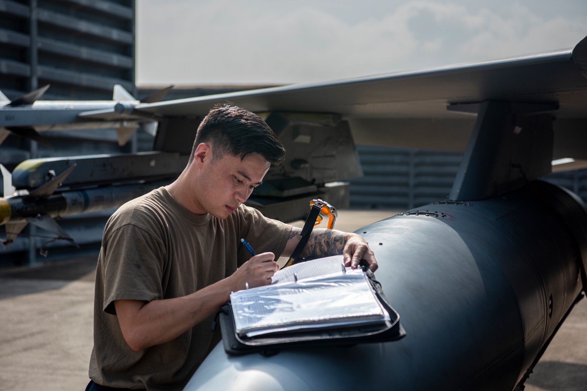 Senior Airman Thomas Yeung, 36th Fighter Generation Squadron crew chief, documents his post-flight maintenance during a training sortie at Gwangju Air Base, Republic of Korea, Aug. 18, 2022.