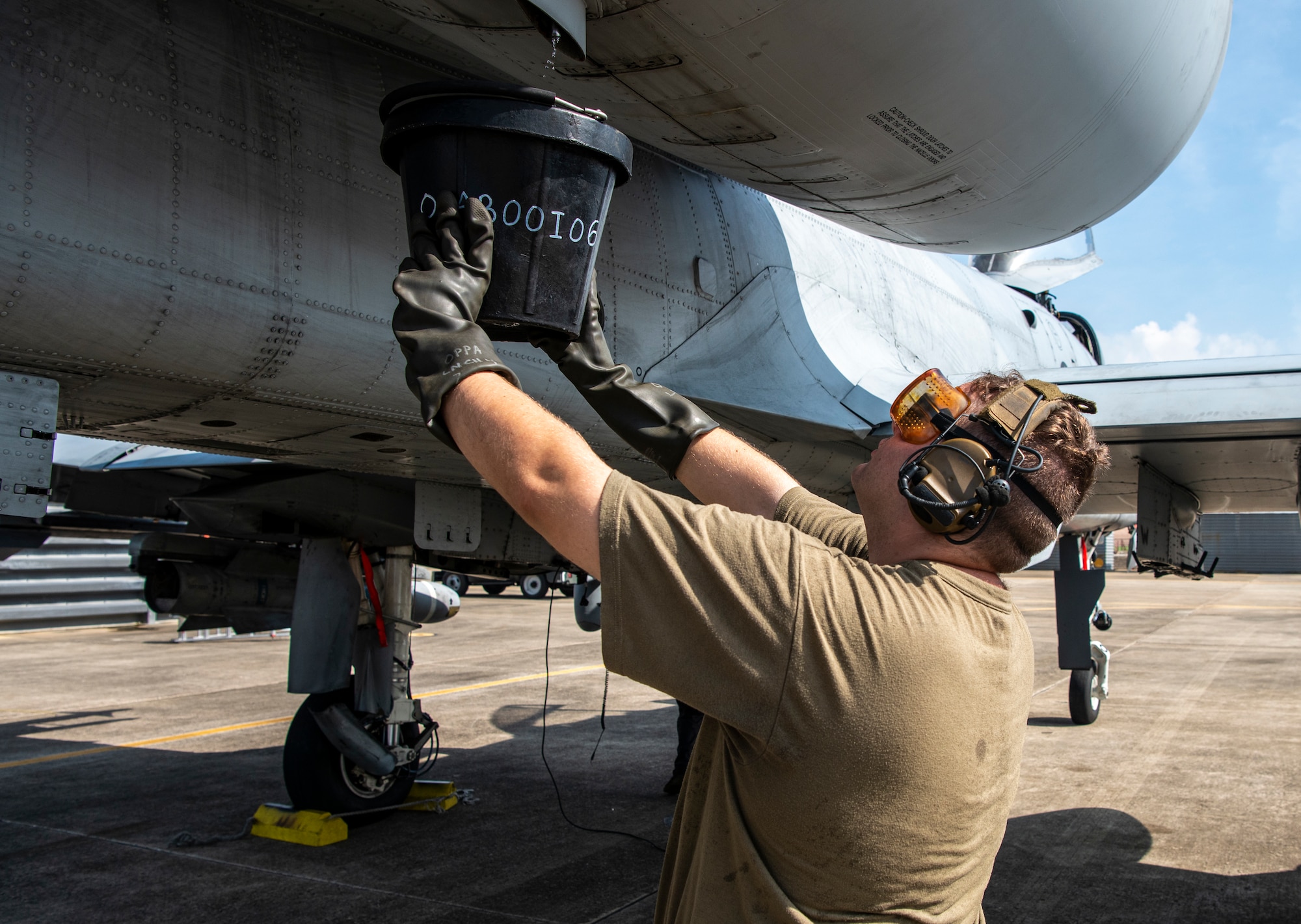 Staff Sgt. John Wood, 25th Fighter Generation Squadron crew chief, drains excess fuel from an A-10C Thunderbolt II during a training sortie at Gwangju Air Base, Republic of Korea, Aug. 18, 2022
