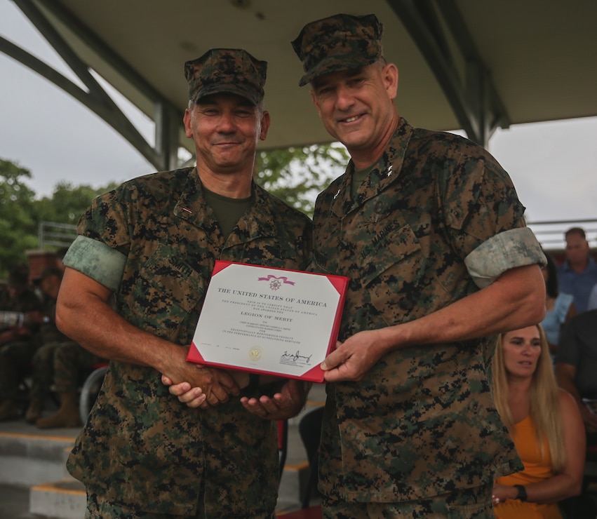U.S. Marine Corps Chief Warrant Officer 5 Joshua S. Smith, left, and Maj. Gen. Francis Donovan, both with 2d Marine Division, pose for a photo during a retirement ceremony on Camp Lejeune, North Carolina, July 15, 2022. Smith retires after 30 years of honorable service. (U.S. Marine Corps photo by Lance Cpl. Emma L. Gray)
