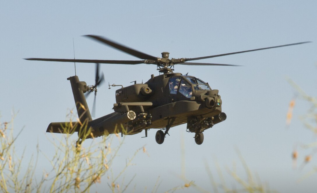 helicopter hovers over field of yellow flowers