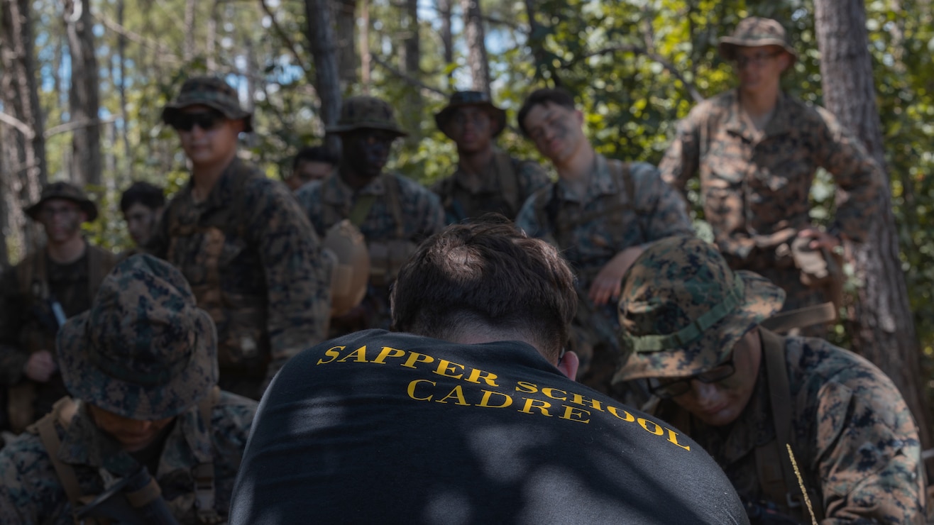 U.S. Marine Corps Sgt. Michael Trull, a SAPPER School instructor with 2d Combat Engineer Battalion (CEB), 2d Marine Division (MARDIV), instructs the squad leaders during the SAPPER Squad Competition on Camp Lejeune, North Carolina, Aug. 8, 2022. During this exercise, Marines from 1st CEB, 1st MARDIV, and 2d CEB conducted urban demolition training during the annual SAPPER Squad Competition. The competition consisted of a wide array of mission essential tasks under a stressful environment and recognized top talent within the Marine Corps’ combat engineer community. (U.S. Marine Corps photo by Lance Cpl. Megan Ozaki)