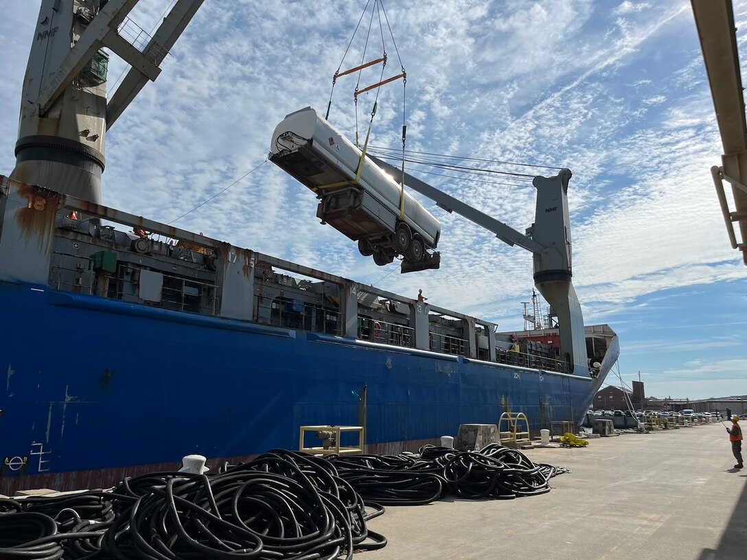 Fuel tanker trailer lifted out of a shipping vessel via crane