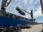 Fuel tanker trailer lifted out of a shipping vessel via crane