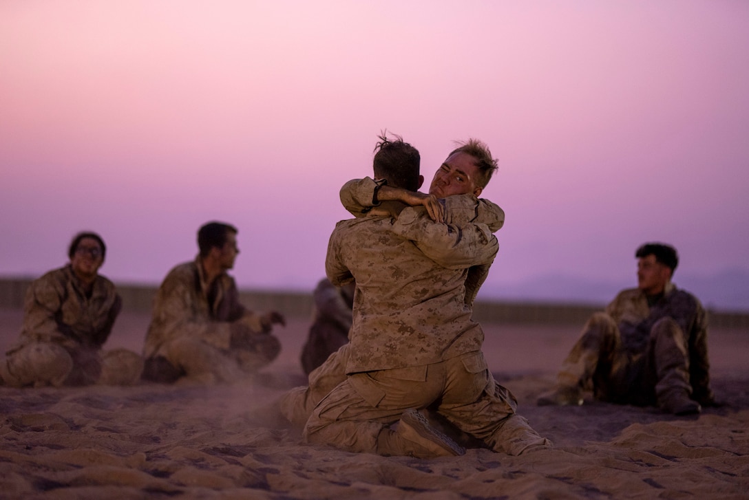 U.S. Marine Corps 2nd Lt. Arthur Deal, left, a Communication Strategy and Operations officer, and Sgt. Joshua McDaniel, right, a ground radio technician, both with Combat Logistics Regiment 1, 1st Marine Logistics Group, grapple during Marine Corps martial arts belt advancement training at a Logistics Support Area established in the Kingdom of Saudi Arabia during exercise Native Fury 22, Aug. 18, 2022. Native Fury 22 is vital for strengthening the United States’ long-standing relationship with Saudi Arabian Armed Forces. The exercise enhances combined tactics, maritime capabilities and promotes long-term regional stability. (U.S. Marine Corps Photo by Cpl. Patrick Katz)