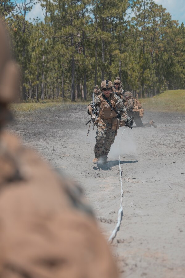 U.S. Marines with 2d Combat Engineer Battalion (CEB), 2d Marine Division (MARDIV), run through cleared paths during the SAPPER Squad Competition on Camp Lejeune, North Carolina, Aug. 10, 2022.