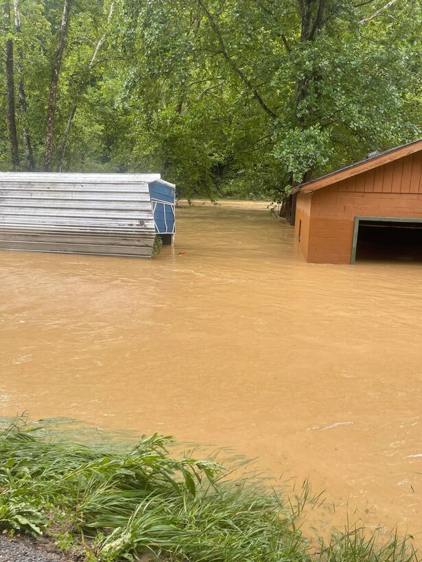 Hall watched rushing flood waters rise and destroy the first story of his house from a hill behind his home which sits about 20 yards from Troublesome Creek.