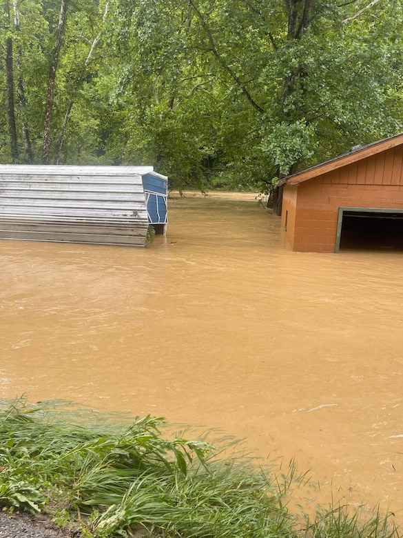 Hall watched rushing flood waters rise and destroy the first story of his house from a hill behind his home which sits about 20 yards from Troublesome Creek.