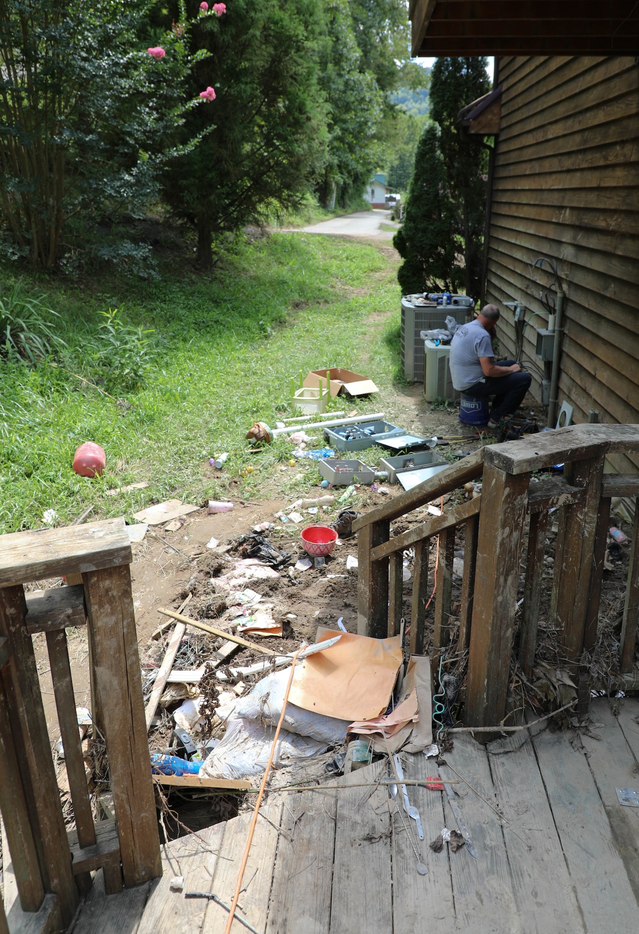 Hall watched rushing flood waters rise and destroy the first story of his house from a hill behind his home which sits about 20 yards from Troublesome Creek.