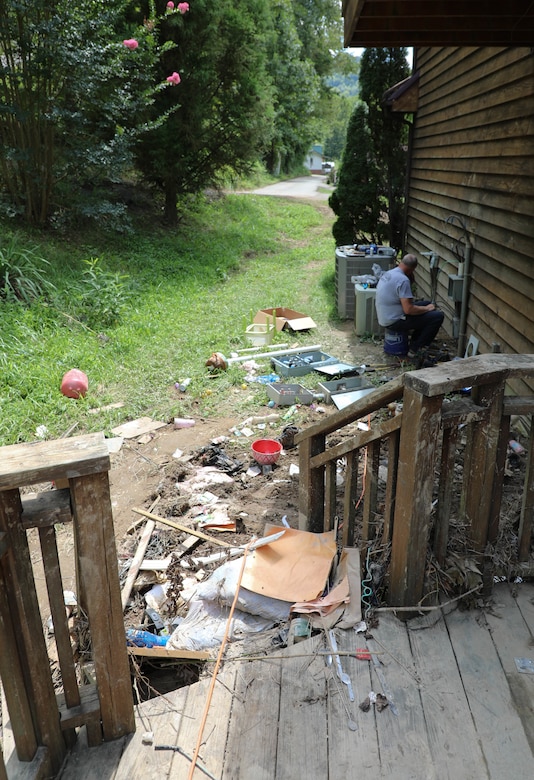 Hall watched rushing flood waters rise and destroy the first story of his house from a hill behind his home which sits about 20 yards from Troublesome Creek.