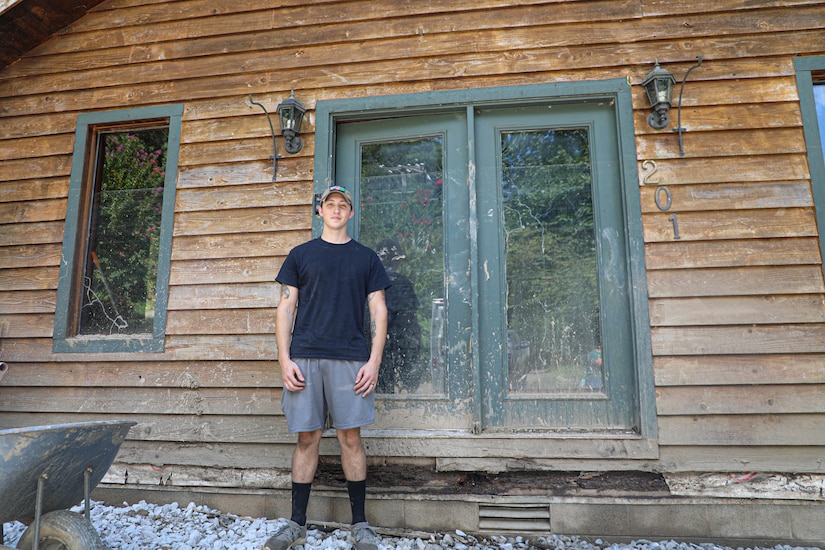 Hall watched rushing flood waters rise and destroy the first story of his house from a hill behind his home which sits about 20 yards from Troublesome Creek.