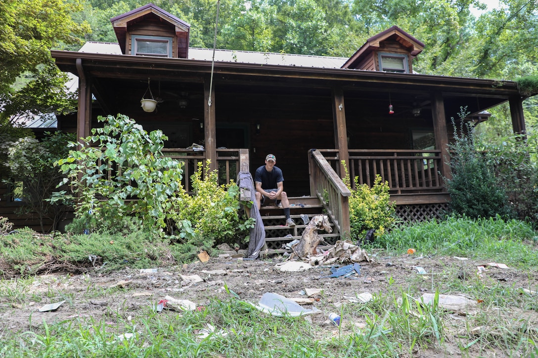 Hall watched rushing flood waters rise and destroy the first story of his house from a hill behind his home which sits about 20 yards from Troublesome Creek.