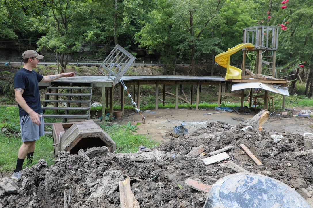 Hall watched rushing flood waters rise and destroy the first story of his house from a hill behind his home which sits about 20 yards from Troublesome Creek.