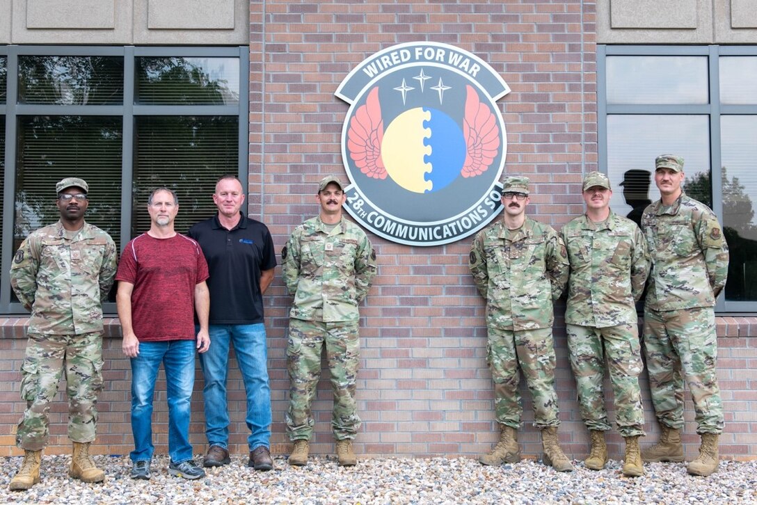 United States Air Force 28th Communications Squadron personnel pose for a group photo at Ellsworth Air Force Base, S.D., Aug. 2, 2022.