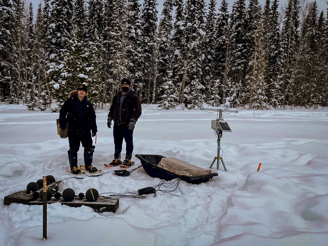 Matt Kamrath, a research physical scientist with the U.S. Army Engineer Research and Development Center’s Cold Regions Research and Engineering Laboratory (CRREL), and Zach Zody, a CRREL research mechanical engineer, connect the cables from microphones to a multichannel recorder in Fairbanks, Alaska.