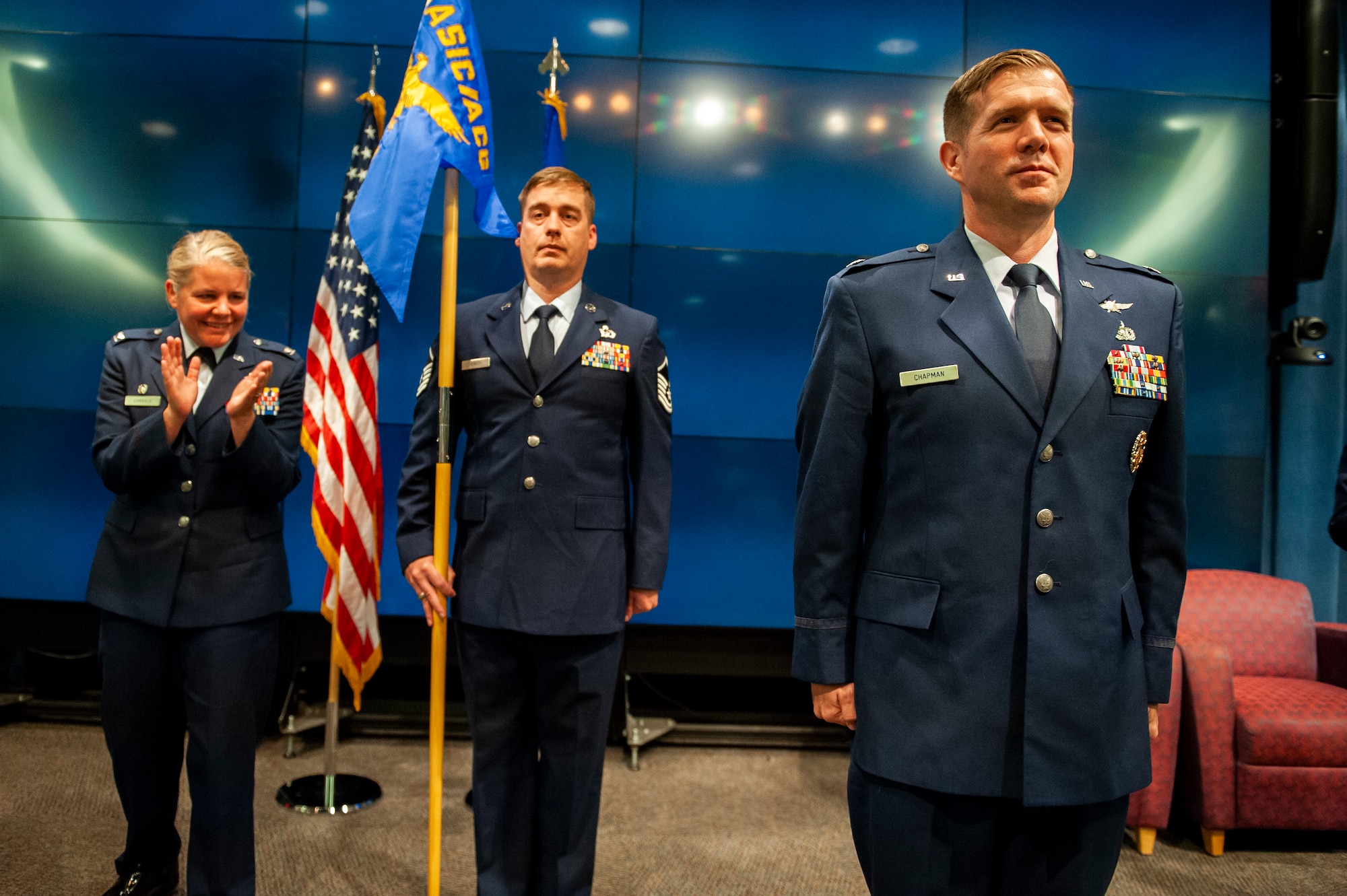 Lt. Col. Joseph D. Chapman, inbound Information Warfare Analysis Squadron commander, stands at attention as Col. Catherine A. Gambold, Air and Cyberspace Intelligence Group commander, leads a round of applause in recognition of Chapman’s new role as squadron commander, June 29, Wright-Patterson Air Force Base. Chapman previously served as the deputy chief of the Information Warfare Division at Ramstein Air Base, Germany. (U.S. Air Force photo by Senior Airman Kristof J. Rixmann)