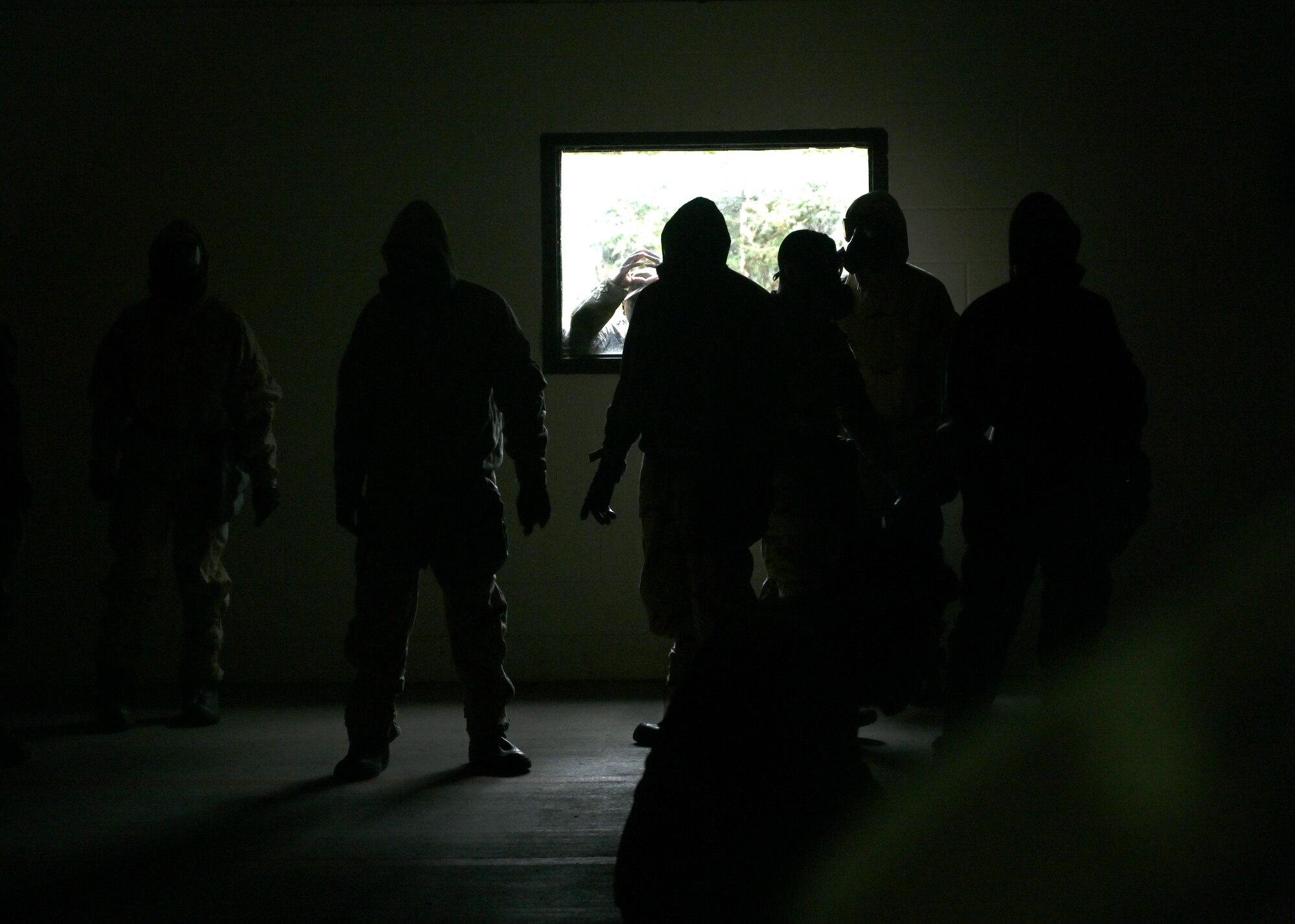 U.S. Air Force Airmen with the 627th Civil Engineer Squadron enter the gas chamber during a joint exercise at Joint Base Lewis-McChord, Washington, Aug. 26, 2022. The 627th CES partnered with the 349th Chemical Company for a chemical, biological, radiological, and nuclear exercise to ensure Airmen are proficient in using a gas mask to prepare them for a biological or chemical attack. (U.S. Air Force photo by Senior Airman Callie Norton)