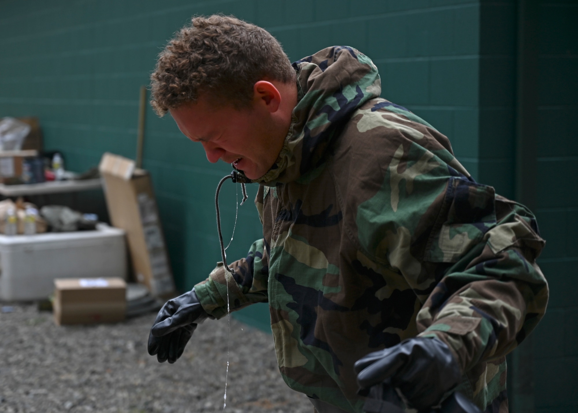 U.S. Air Force Senior Airman Steven Lapworth, electrical systems apprentice with the 627th Civil Engineer Squadron, exits the gas chamber during a joint exercise at Joint Base Lewis-McChord, Washington, Aug. 26, 2022. The 627th CES partnered with the 349th Chemical Company for a chemical, biological, radiological, and nuclear exercise to ensure Airmen are proficient in using a gas mask to prepare them for a biological or chemical attack. (U.S. Air Force photo by Senior Airman Callie Norton)