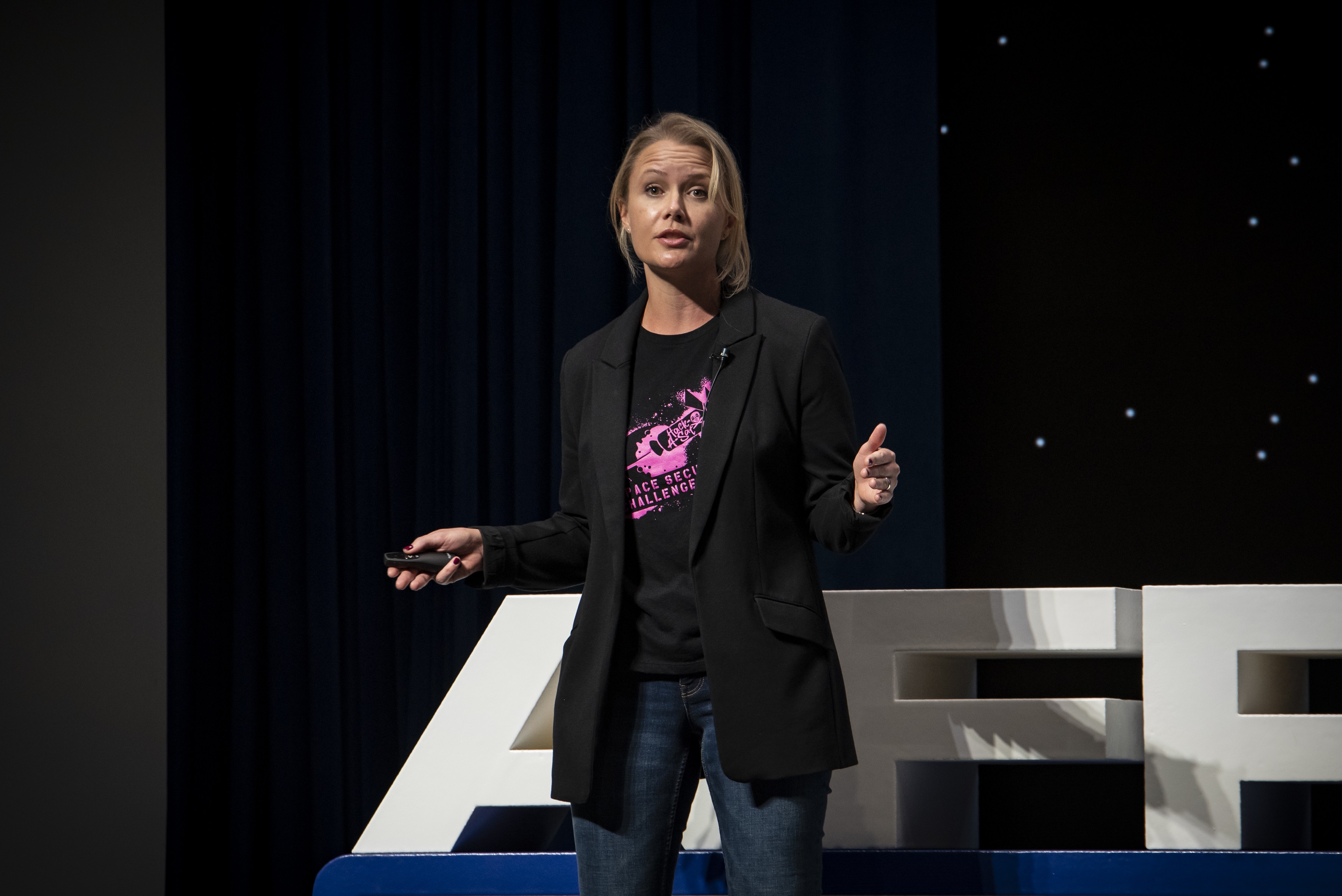 Delia Jesaitis, a communications lead action officer, presents a talk on satellite security during AFRL Inspire. The Air Force Research Laboratory hosted this special TEDx-style event at the Air Force Institute of Technology's Kenney Hall at Wright-Patterson Air Force Base, Aug. 23, 2022. (U.S. Air Force photo / Rick Eldridge)