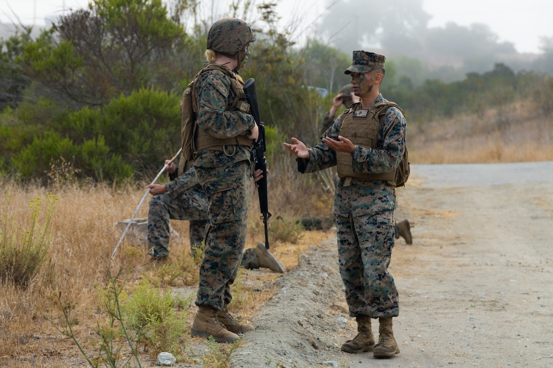 U.S. Marine Corps Sgt. an instructor with Headquarters and Support Battalion's Corporals Course 4-22, instructs students during a patrol on Marine Corps Base Camp Pendleton, California, Aug. 17, 2022. Corporals Course provides Marines with the skills and knowledge necessary to become successful small-unit leaders. (U.S. Marine Corps photo by Lance Cpl.  Espitia)