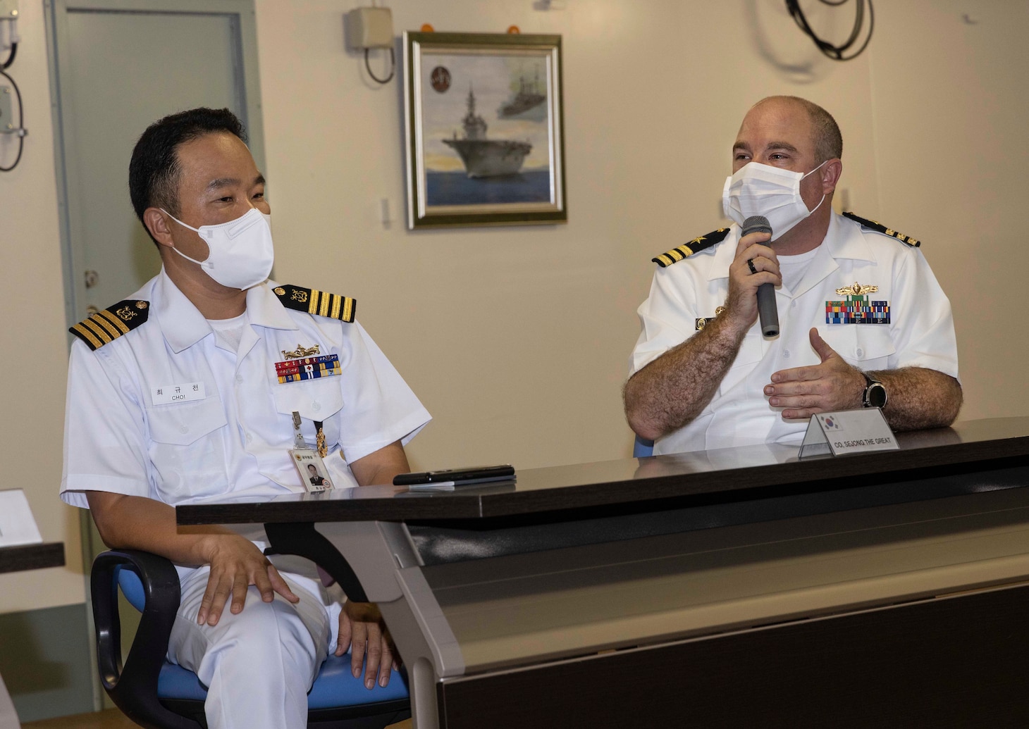 Cmdr. Joseph McGettigan, commanding officer of Arleigh Burke-class guided-missile destroyer USS Higgins (DDG 76), makes a statement during the opening ceremony for Pacific Vanguard (PV) 22-1 with Republic of Korea Navy Capt. Gyucheon Choi, commanding officer of Republic of Korea Ship Navy destroyer Sejong the Great (DDG 991), present aboard Japan Maritime Self-Defense Force helicopter destroyer JS Izumo (DDH 183) pierside at Naval Base Guam, Aug. 25. PV 22-1 is an exercise with a focus on interoperability and the advanced training and integration of allied maritime forces.