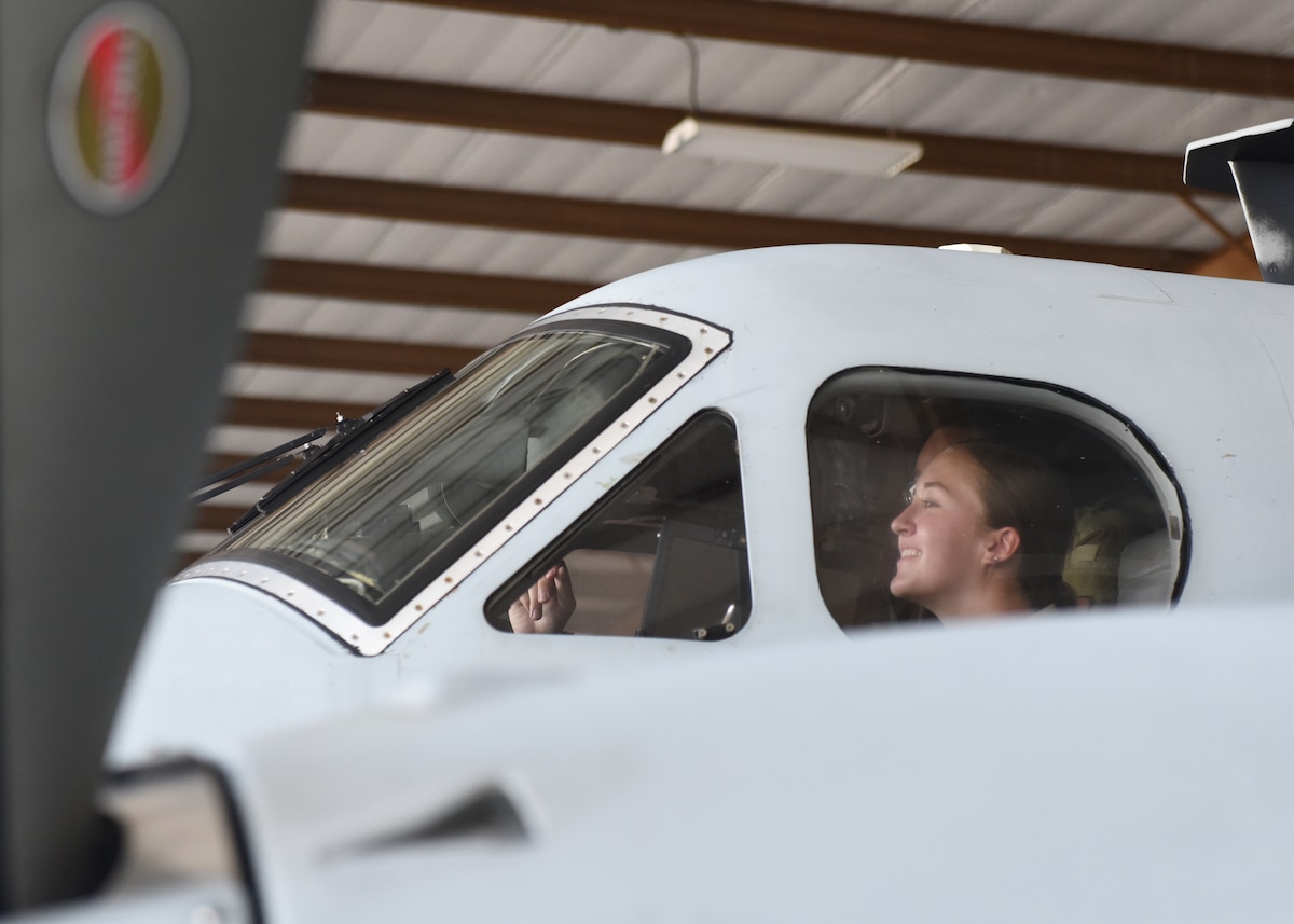 A student assigned to the 316th Training Squadron sits in the cockpit of an MC-12W inside a hangar at San Angelo Regional Airport-Mathis Field, Texas, Aug. 24, 2022. Goodfellow Air Force Base intelligence, surveillance, and reconnaissance instructors and students traveled to the airport to gain first-hand experience with this aircraft, which is assigned to 137th Special Operations Wing, Oklahoma National Guard. (U.S. Air Force photo by Airman 1st Class Zachary Heimbuch)