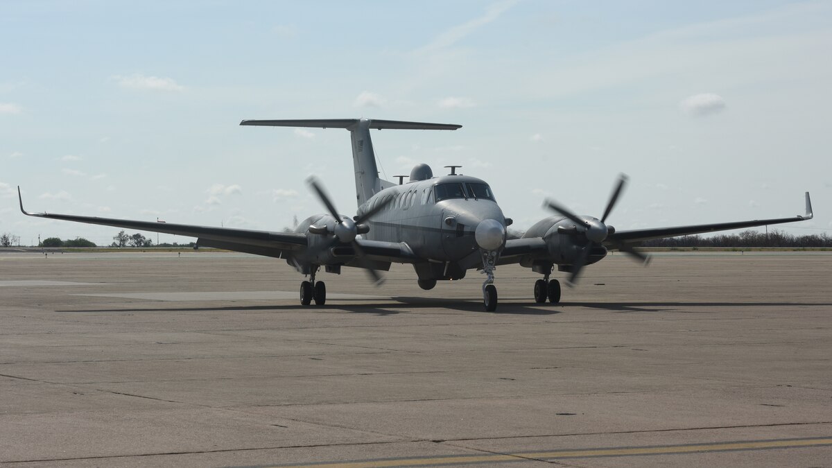 An MC-12W assigned to the 137th Special Operations Wing, Oklahoma National Guard, taxis into a hangar at San Angelo Regional Airport-Mathis Field, Texas, Aug. 24, 2022. The MC-12W is a twin-engine turbo prop aircraft used for intelligence, surveillance and reconnaissance missions in support of ground forces around the world.  (U.S. Air Force photo by Airman 1st Class Zachary Heimbuch)