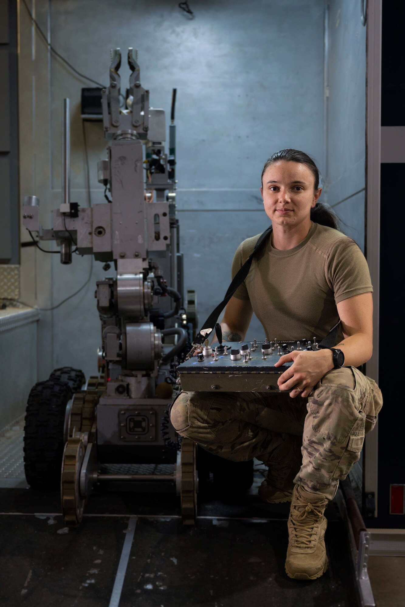 U.S. Air Force Senior Airman Tiela Roland, 36th Civil Engineer Squadron explosive ordinance disposal team member, poses with an Andros F-6 robot for a photo at Andersen Air Force Base, Guam, Aug. 4, 2022.