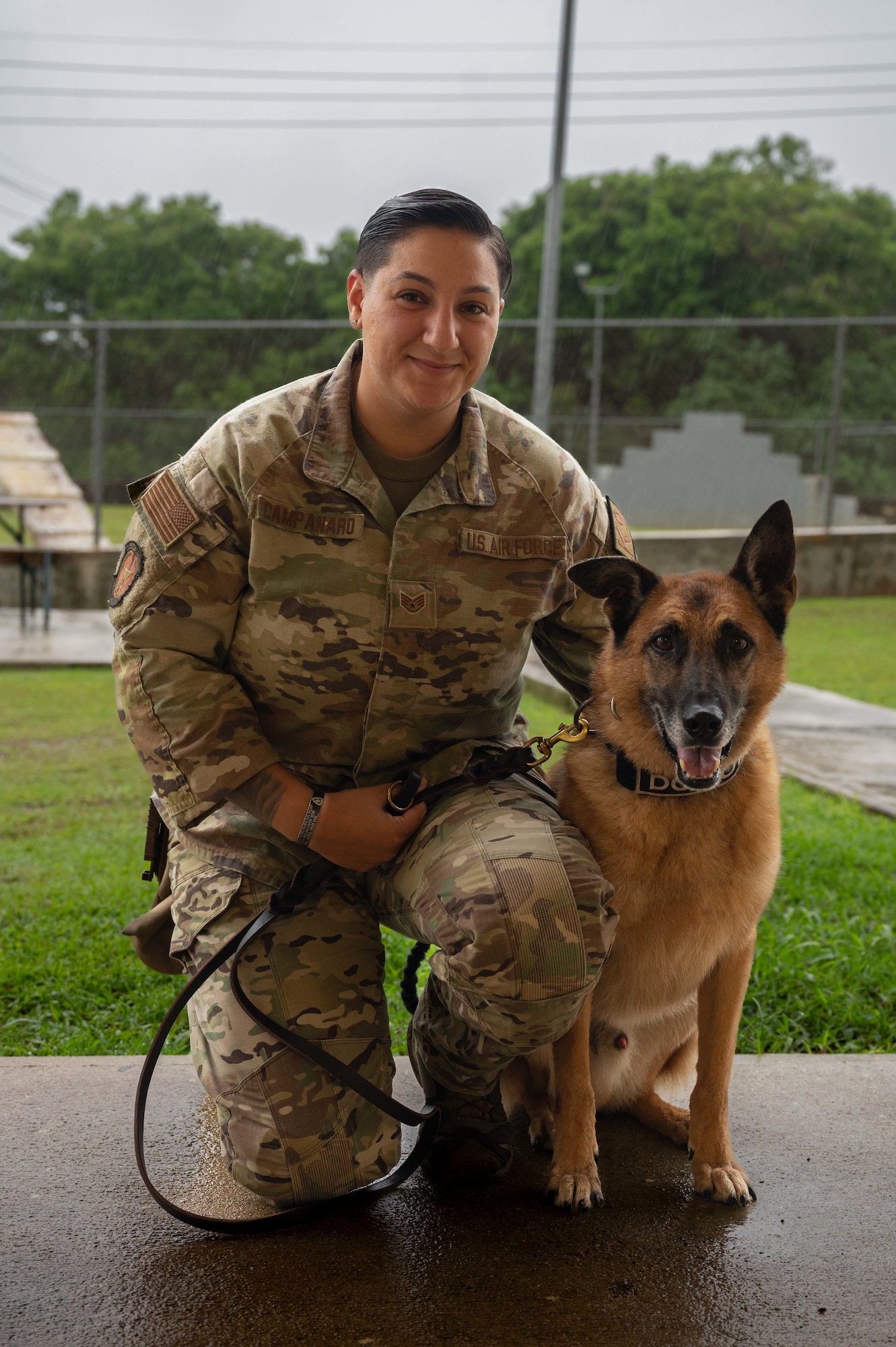U.S. Air Force Staff Sgt. Alexandra Campanaro, 36th Security Forces Squadron military working dog handler, poses for a photo with Dex, a 36 SFS MWD at Andersen Air Force Base, Guam, Aug. 22, 2022.