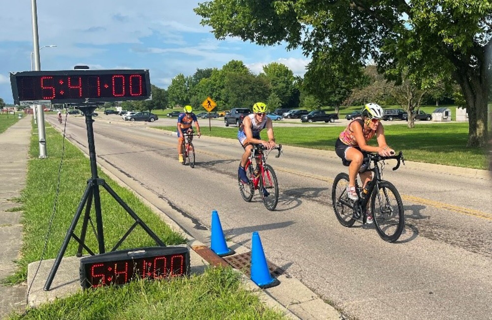 Three cyclists cross the finish line.