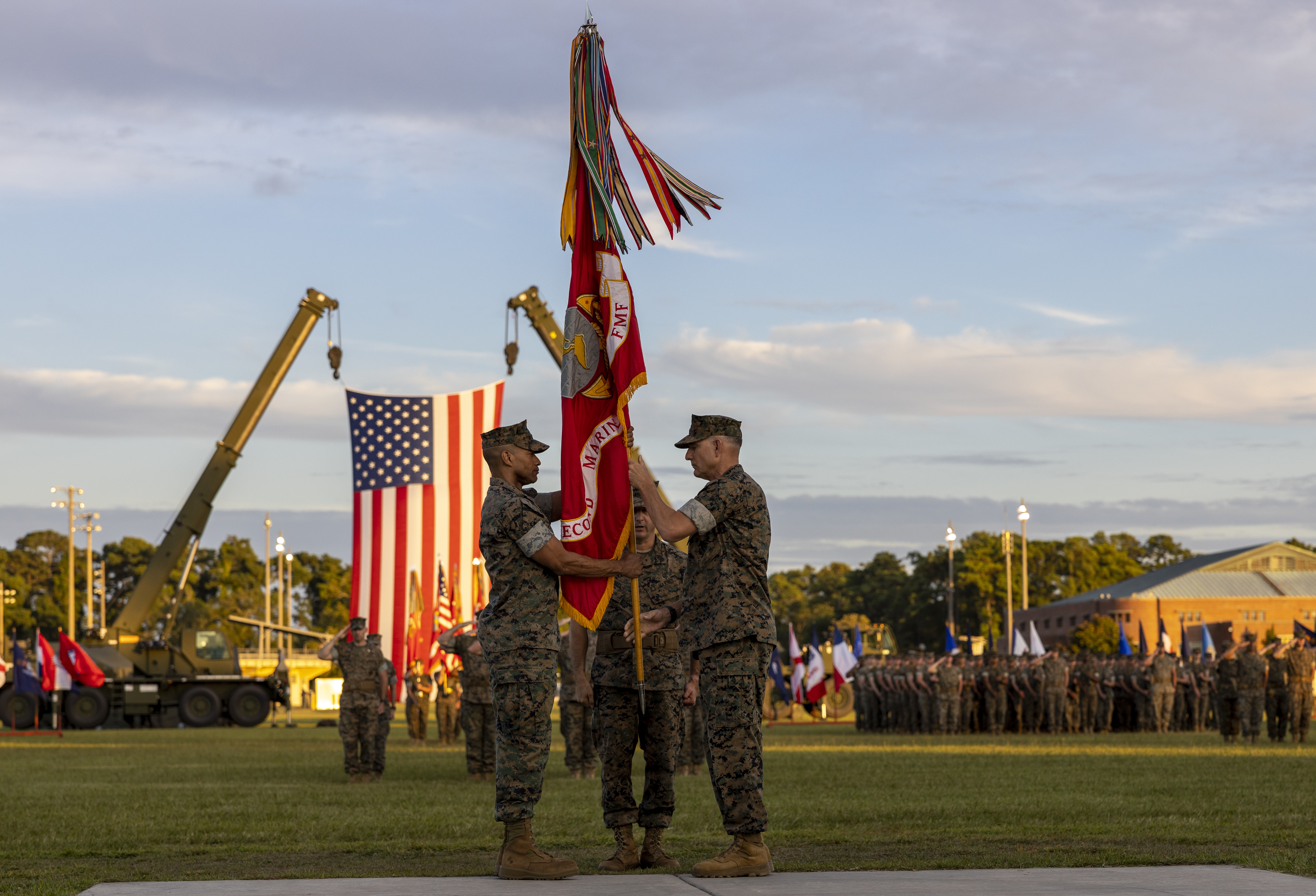 U.S. Marine Corps Maj. Gen. Francis Donovan, right, the outgoing commanding general (CG) of 2d Marine Division (MARDIV), passes the division colors to Brig. Gen. Calvert Worth, the incoming CG of 2d MARDIV, at a change of command ceremony on Camp Lejeune, North Carolina, Aug. 18, 2022. The passing of the colors represents the transfer of the roles and responsibilities between the division commanders. (U.S. Marine Corps photo by Staff Sgt. Kimberlyn Patterson)