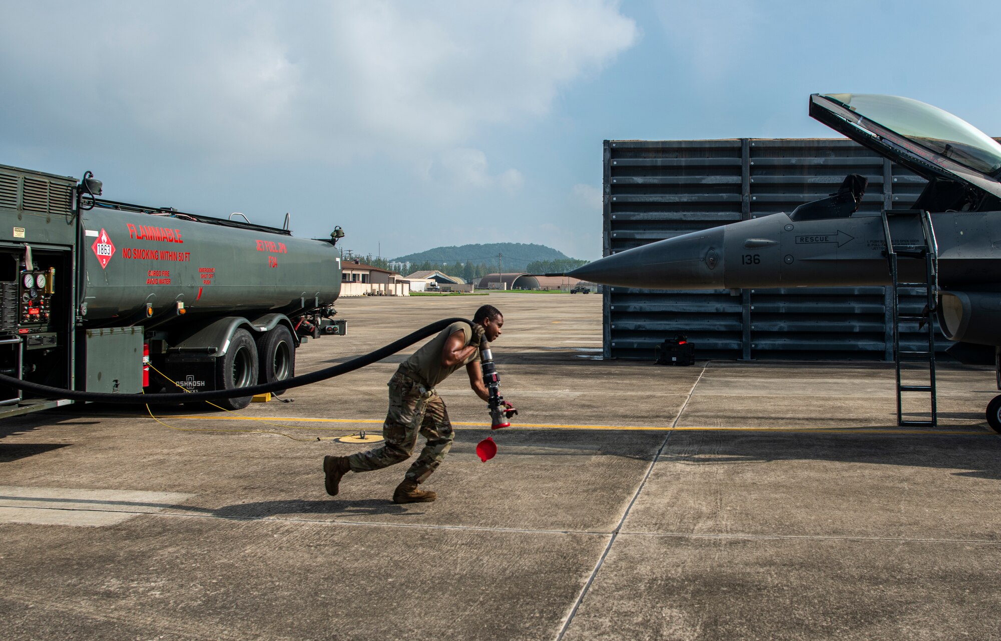 Airman 1st Class Justin Hill, 51st Logistics Readiness Squadron fuels specialist, refuels an F-16 Fighting Falcon during a training sortie at Gwangju Air Base, Republic of Korea, Aug. 18, 2022.