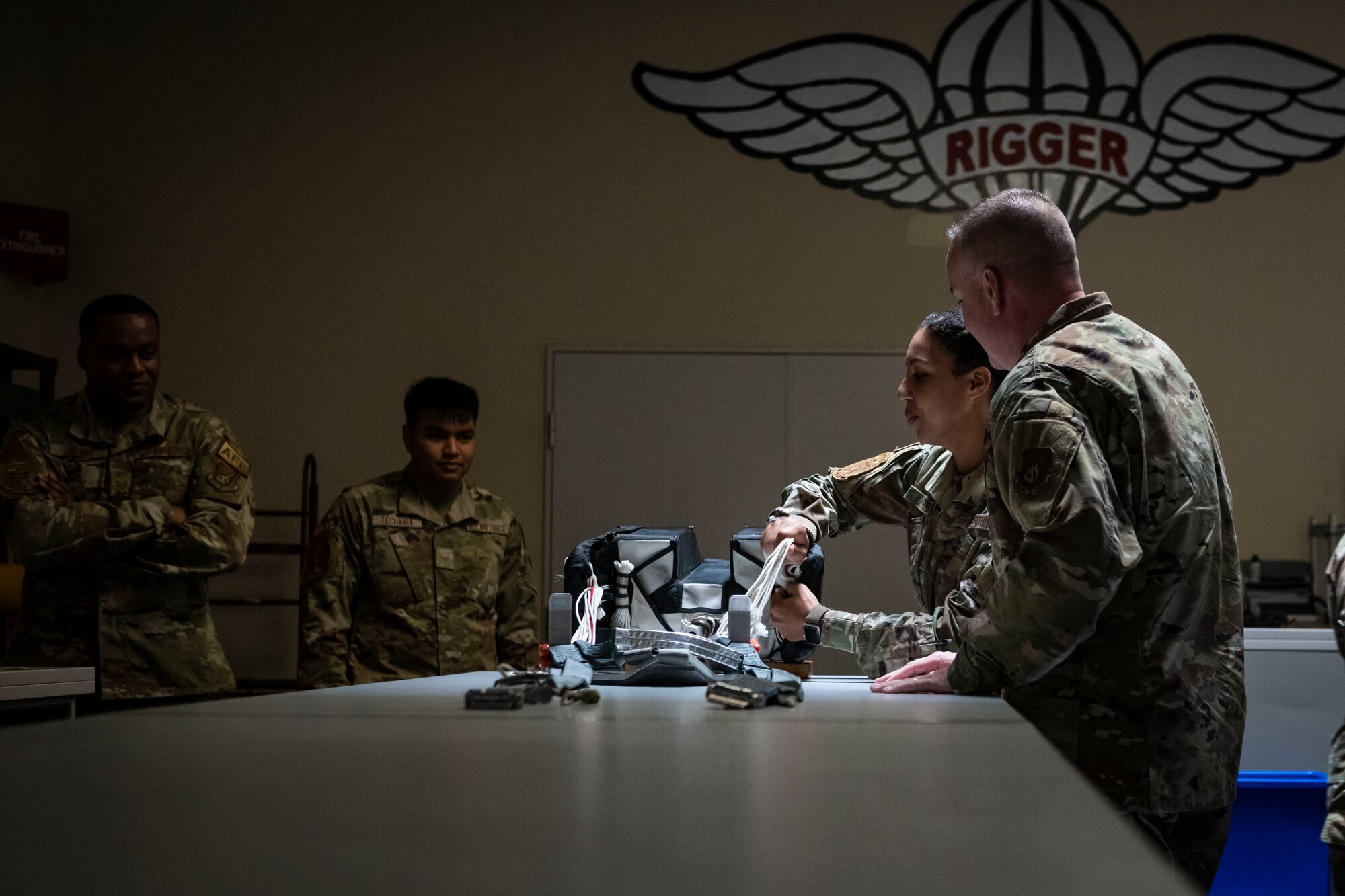 U.S. military members unpack a parachute.