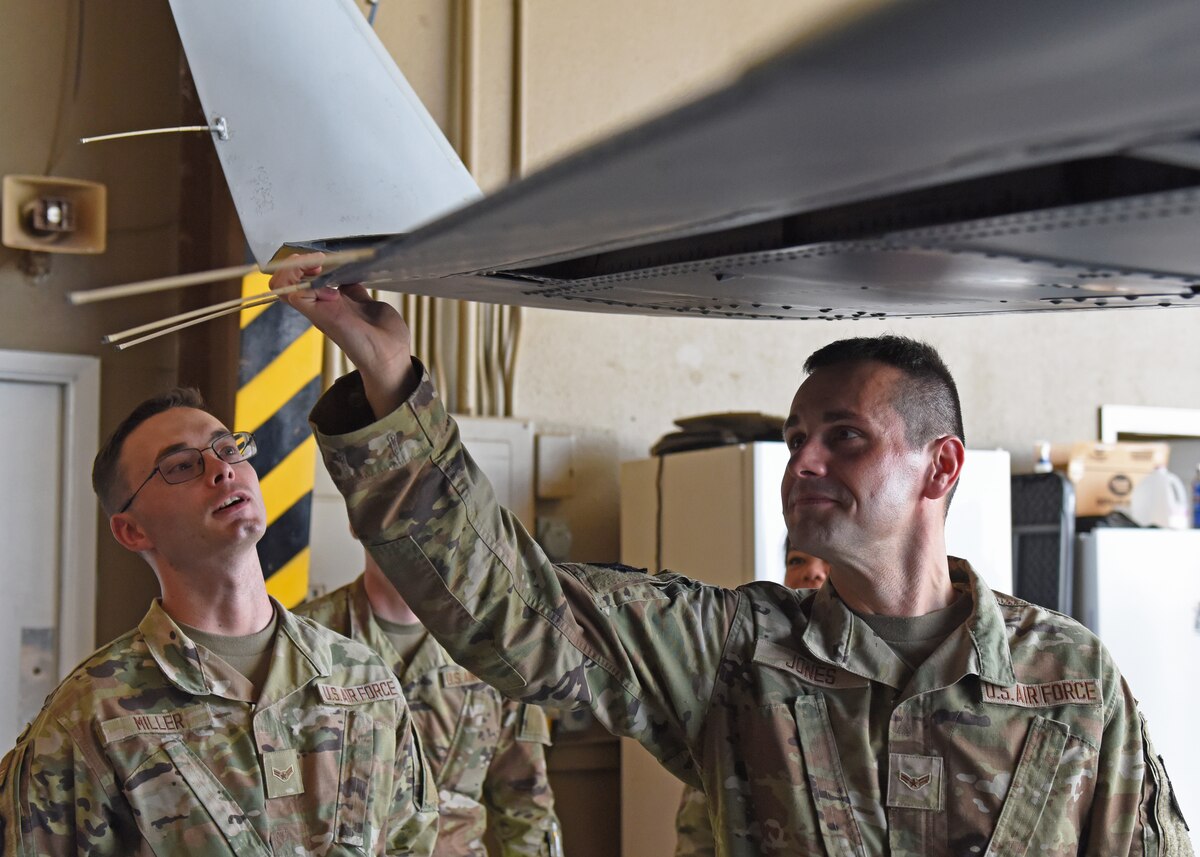 Students assigned to the 316th Training Squadron check the flaps of an MC-12W in a hangar at San Angelo Regional Airport-Mathis Field, Texas, Aug. 24, 2022. The mission of the 316th TRS is to train, develop and inspire intelligence, surveillance and reconnaissance cryptologic leaders. (U.S. Air Force photo by Airman 1st Class Zachary Heimbuch)